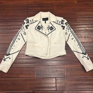 BCBG MaxAzria moto jacket with black embroidery and zipper detail.